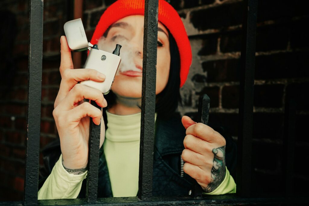 man in black jacket holding white smartphone